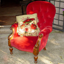 A Portrait of a Woman Reading in a Red Armchair